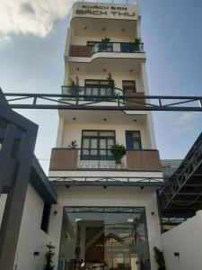 a building with a balcony with plants on it at Khách Sạn Bách Thư Tây Ninh in Tây Ninh