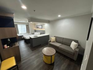 a living room with a couch and a bed at Quality Inn & Suites in Santa Rosa +46 photos
