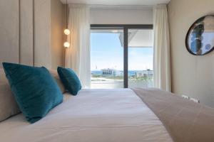 a bedroom with a large bed with a large window at EL Eden casa 71 in Málaga +42 photos