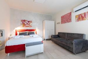 a bedroom with a large bed and a couch at Tra Lago Maggiore e lago d'Orta Appartamento FUOCO in Colazza