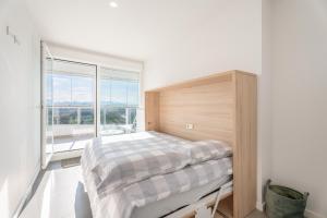 a bedroom with a bed and a large window at Tu Escapada En Canet in Canet de Berenguer +33 photos