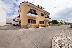 a building on the side of a road at Casa Amarela in Tavira