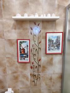 a bathroom with three pictures on a wall at Casa Marina in La Posta +40 photos