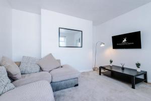 a living room with a couch and a table at Stylish 3 bed house sleeps 5 free parking in Dudley Hill