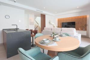 a living room with a table and chairs at Villa Almendro Santa Rosalia Lake and Life Resort by PREMIUM SPAIN PROPERTIES in Torre-Pacheco