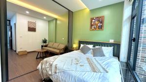 a bedroom with a large bed and a chair at Apartment in Ho Tay in Hanoi