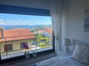 a bedroom with a large window with a view at Villa Maris Izola in Izola