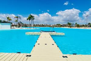 a dock in the middle of a large blue pool at Villa Almendro Santa Rosalia Lake and Life Resort by PREMIUM SPAIN PROPERTIES in Torre-Pacheco
