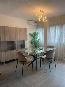 a dining room with a glass table and chairs at Appartement T3 in Abidjan