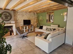 a living room with two couches and a fireplace at L'escapade / Maison de campagne in Veigné