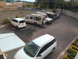 a group of vehicles parked in a parking lot at Sironosim Garden Hotel ltd in Oloitokitok 