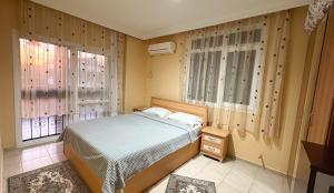 a bedroom with a bed and two windows at Villa Didim in Didim +21 photos