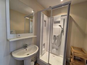 a white bathroom with a shower and a sink at Les Loges Du Beffroi - La Cloche Dorée & Parking privé in Arras