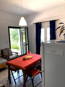 a kitchen with a table with a red table cloth at Relax and enjoy in Raches +12 photos