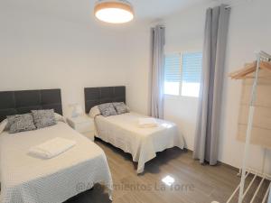 Postel nebo postele na pokoji v ubytování Casa Marenga - Alojamientos La Torre