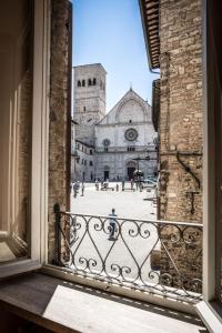 ein offenes Fenster mit Blick auf eine Kathedrale in der Unterkunft Apartment Assisi Cattedrale in Assisi