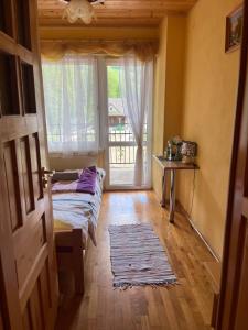 a room with a bed and a large window at Turbacz pokoje gościnne in Ochotnica Górna +36 photos