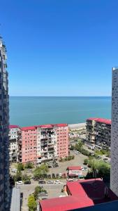 a view of a city with buildings and the ocean at Hedi 18 Apartment in Batumi +10 photos