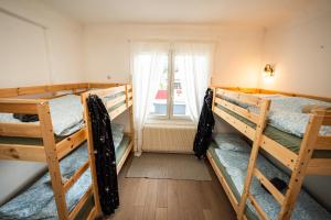 a room with three bunk beds and a window at Capbreton Surf House in Capbreton