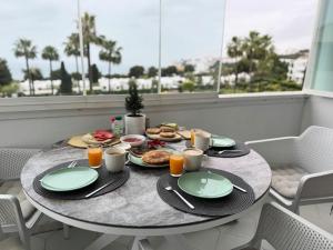 a table with plates of food on a balcony at Amazing sea view apartment in Miraflores in La Cala de Mijas
