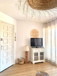 salon z telewizorem i drzwiami w obiekcie Le Petit Colliourenc - Apt climatisé avec terrasse w mieście Collioure +4 zdjęcia