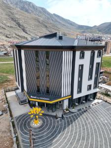 an overhead view of a building with mountains in the background at Rest by Dedeman Elbistan in Elbistan