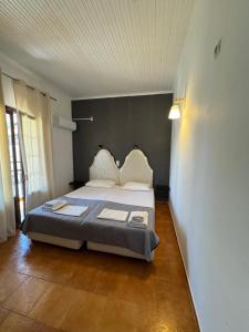 a bedroom with a bed in a room at Kassiopi Apartmets4you III in Kassiopi