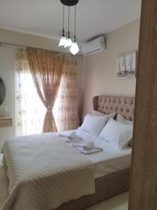 a bedroom with a large bed with a window at Christina's Home in Sarti