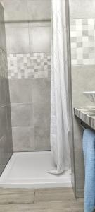 a shower with a white shower curtain in a bathroom at Sol e Praia Alvor 1 in Alvor +35 photos