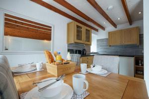 a kitchen with a table with a box of bread at Morton Cottage in Thornhill