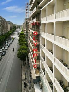 an apartment building with a sign on the side of it at The Oscar Olympic Hotel in Thessaloniki