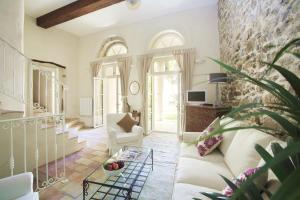 a living room with a couch and a table at Cinq & Sept LGBT Resort for men in Roujan