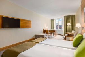 Ein Bett oder Betten in einem Zimmer der Unterkunft NH Zandvoort Hotel