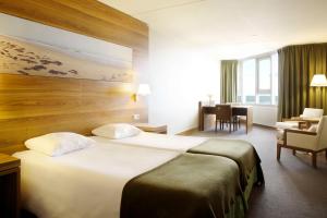 Ein Bett oder Betten in einem Zimmer der Unterkunft NH Zandvoort Hotel