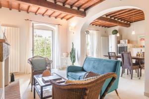 a living room with a blue couch and chairs at Borgo La Fonte - Together in Tuscany in Cortona