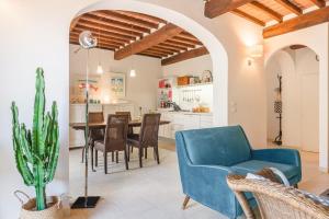 a living room with a blue couch and a table at Borgo La Fonte - Together in Tuscany in Cortona