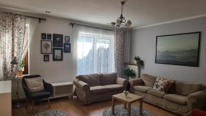 a living room with a couch and a table at ALDAMI in Warsaw