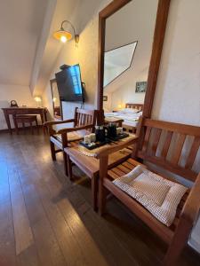 a room with wooden tables and chairs and a television at Skver Studio Apartments in Herceg-Novi