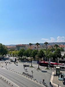 a city with a street with a train in the background at Duplex Place Garibaldi - Close to port, Old Nice in Nice