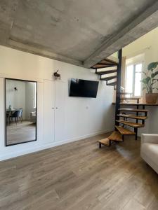 a living room with a staircase and a mirror at Duplex Place Garibaldi - Close to port, Old Nice in Nice