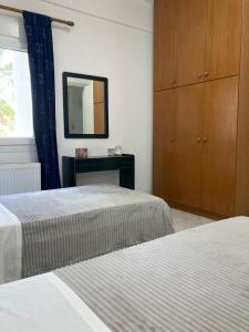 a bedroom with two beds and a dresser and a mirror at Relax and enjoy in Raches