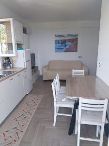 a kitchen and living room with a table and chairs at Villa Arianna Tropea in Tropea +12 photos