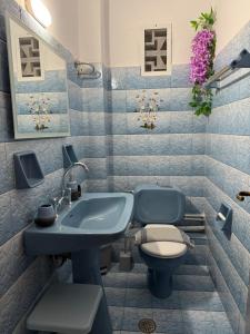 a bathroom with a blue sink and a toilet at Kassiopi Apartmets4you III in Kassiopi