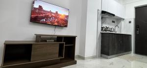 a television hanging on a wall in a living room at Lovely one bedroom in Kilimani near yaya centre in Nairobi