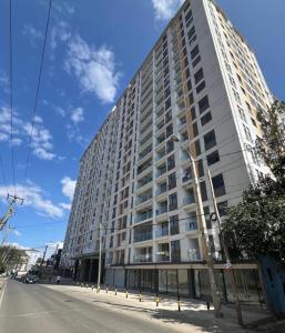 a tall white building on a city street at Lovely one bedroom in Kilimani near yaya centre in Nairobi