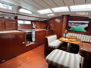a kitchen with a table and chairs in a boat at Sailboat Holiday in Bodrum in Bodrum City