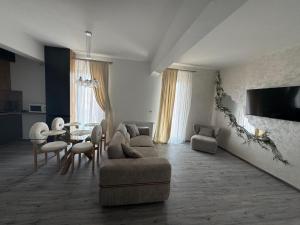 a living room with a couch and a table at David Apartament in Buzău