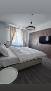 Ένα ή περισσότερα κρεβάτια σε δωμάτιο στο David Apartament