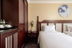 Voodi või voodid majutusasutuse Lotusama Central Hanoi Hotel toas