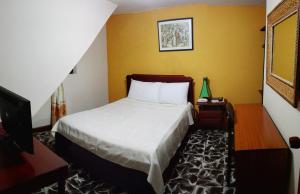 Postel nebo postele na pokoji v ubytování Hotel Alcayata Popayan